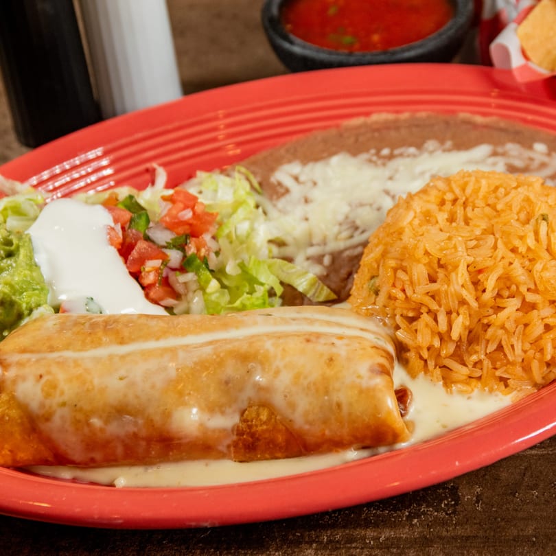 A Reyes Mexican Grill chimichanga with rice, refried beans, guacamole, sour cream, and pico de gallo.